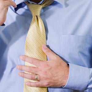 Gentleman placing his palm against his stomach feeling unwell