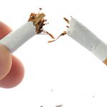 Snapping a cigarette in half in the context over overcoming a smoking addiction