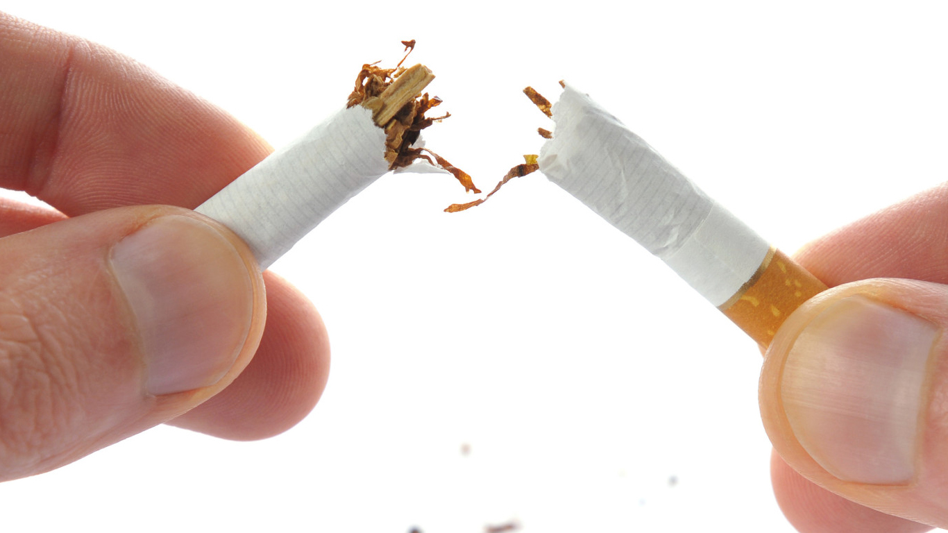 Snapping a cigarette in half in the context over overcoming a smoking addiction